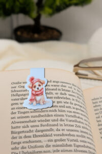 Magnetisches Lesezeichen mit Aquarellhund im rosa Schal.
